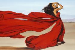 Woman with a long red dress in the desert