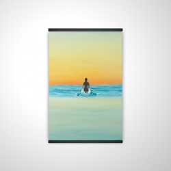 A surfer swimming by dawn